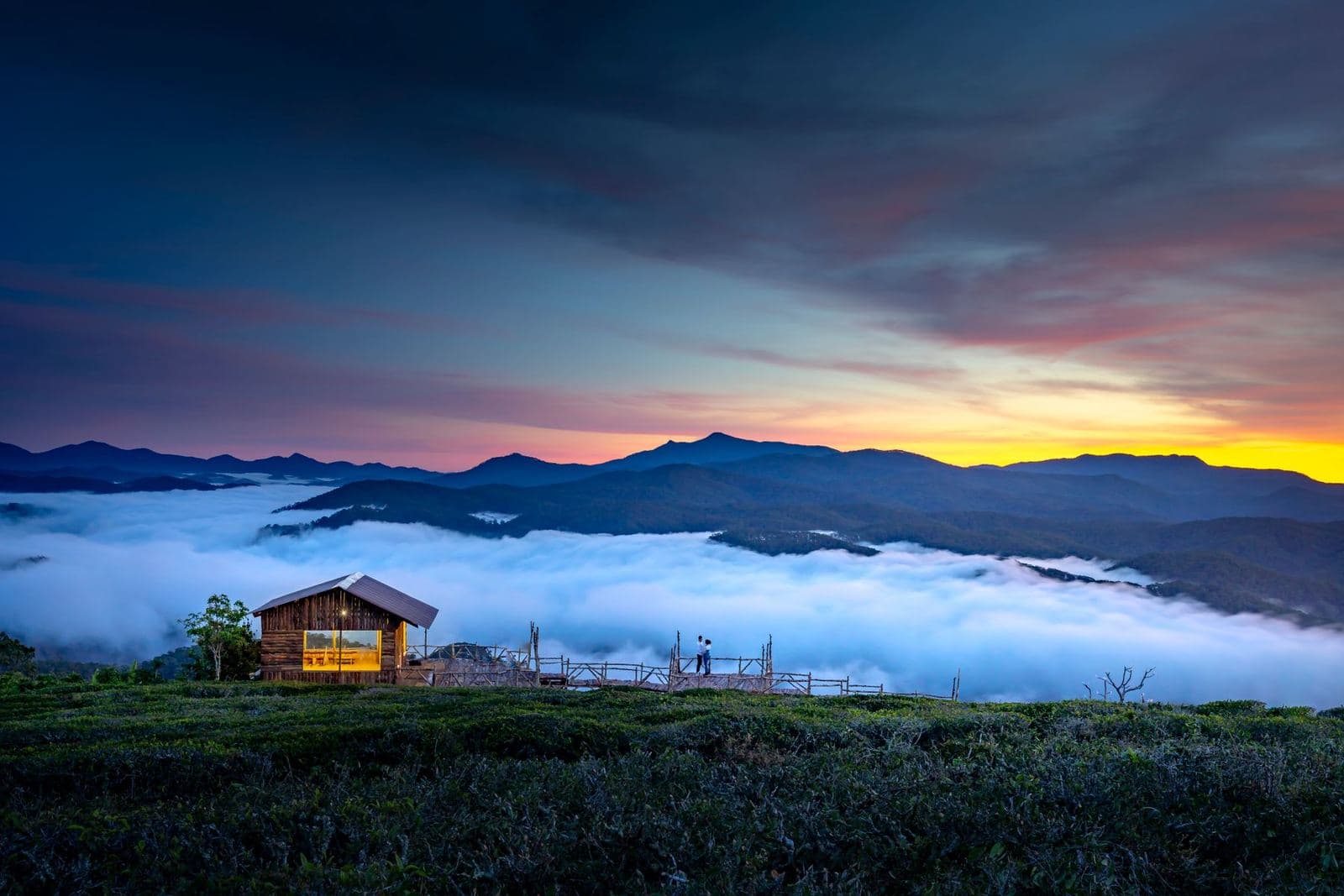 Cottage on a hilltop above the clouds